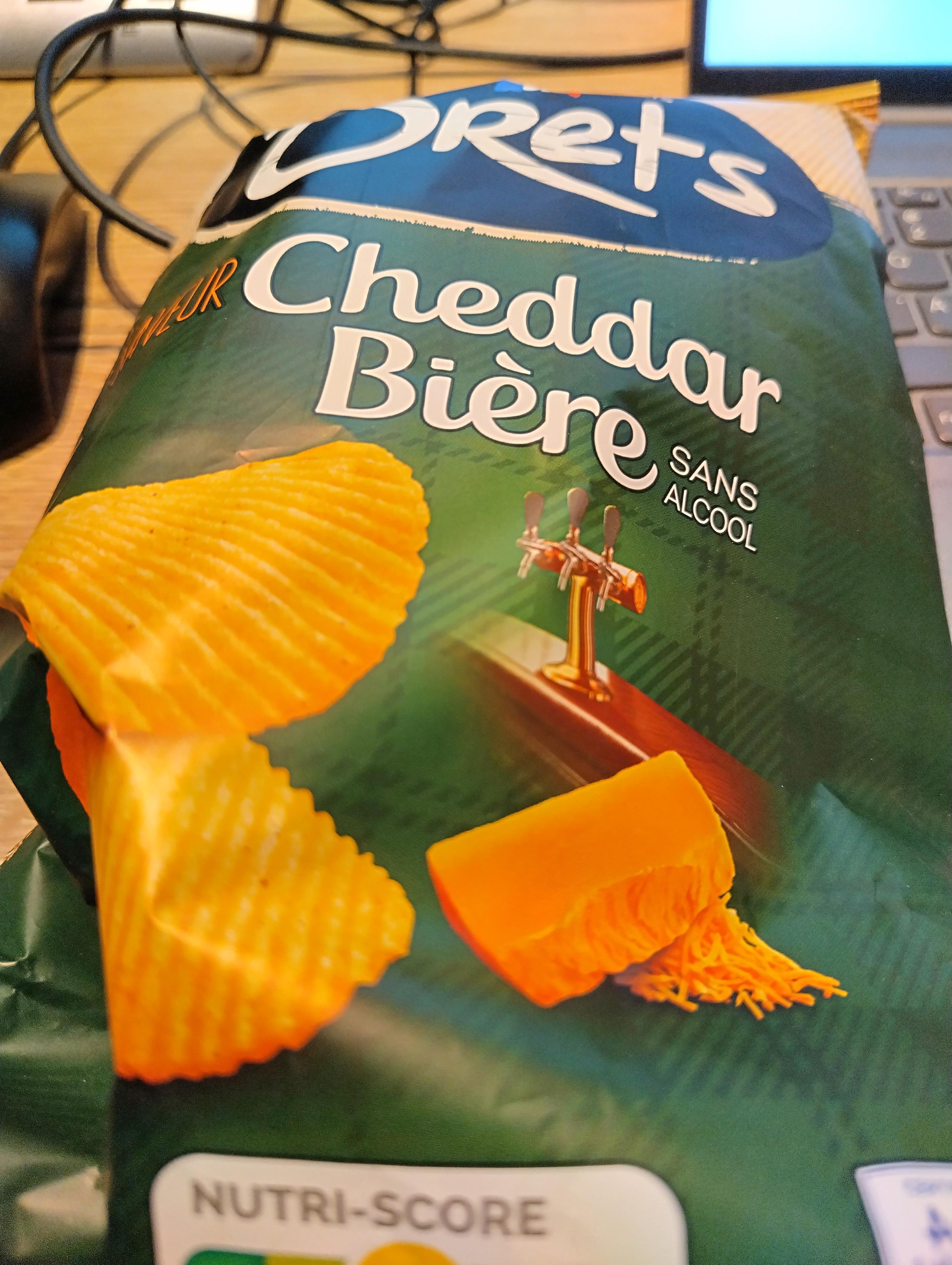 Photo of a bag of Brets Cheddar Beer flavored potato chips. Photo of a bag of Brets Cheddar Beer flavored potato chips.