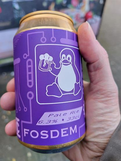Photo of a can of FOSDEM beer with an image of Tux on it.